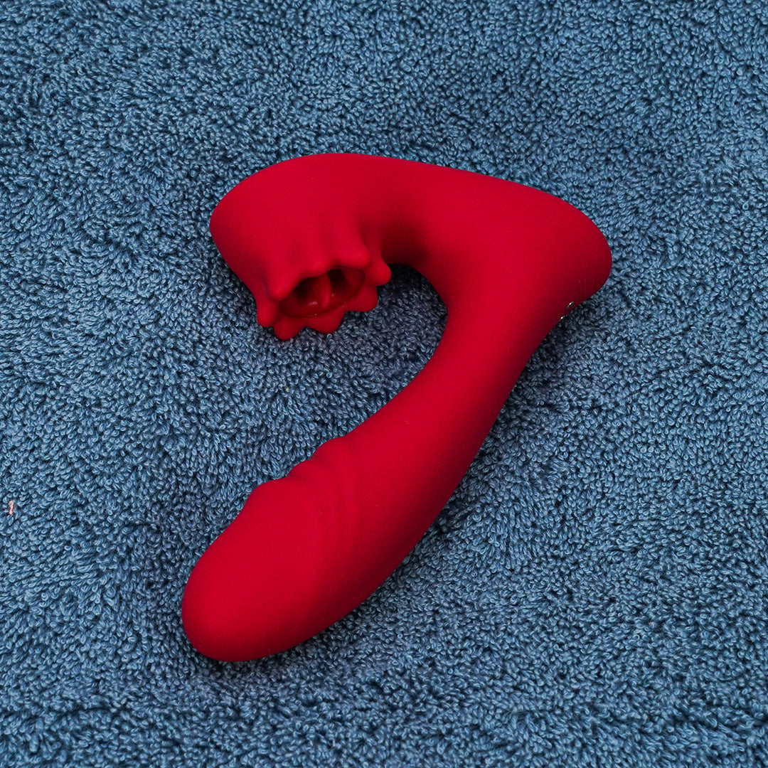 Red clitoral licking vibrator on blue towel