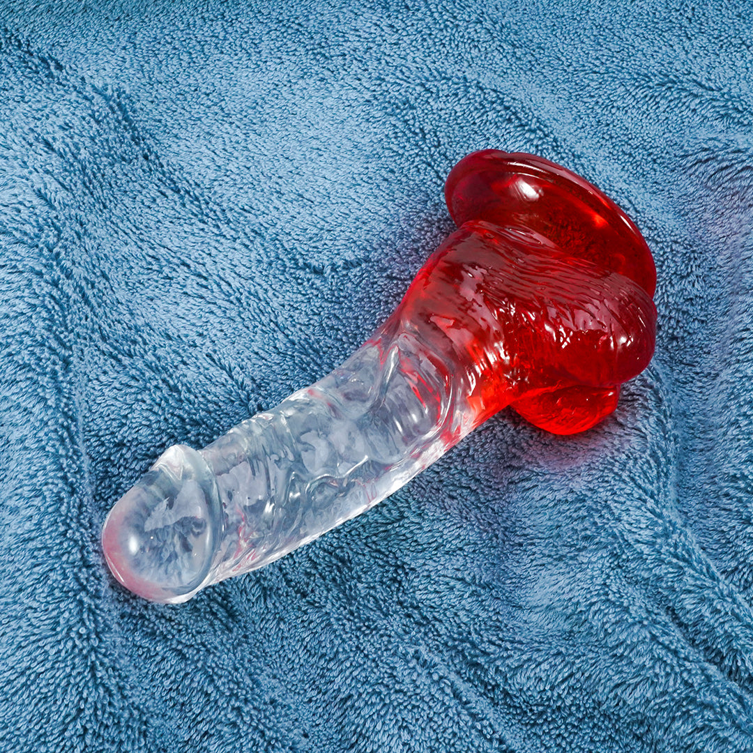 Red and clear gradient dildo on blue background