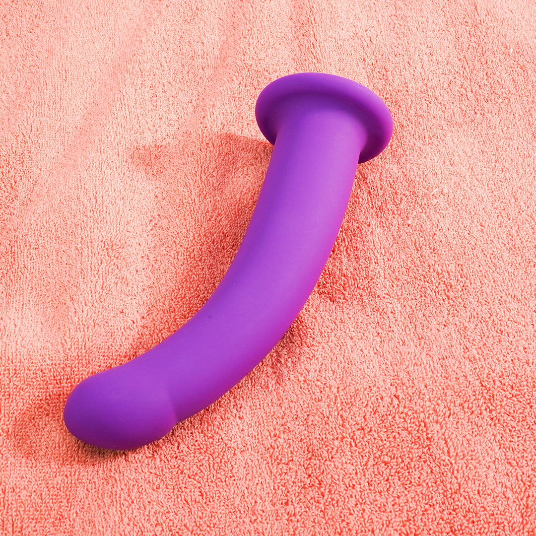 Purple dildo on peach-colored towel