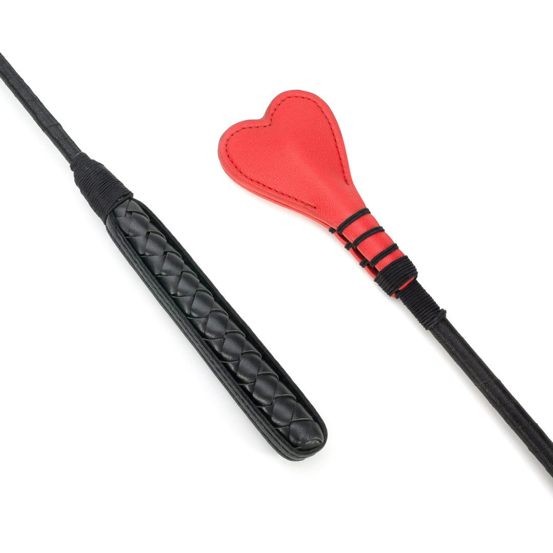 Heart-shaped red leather crop sex toy, couple playful