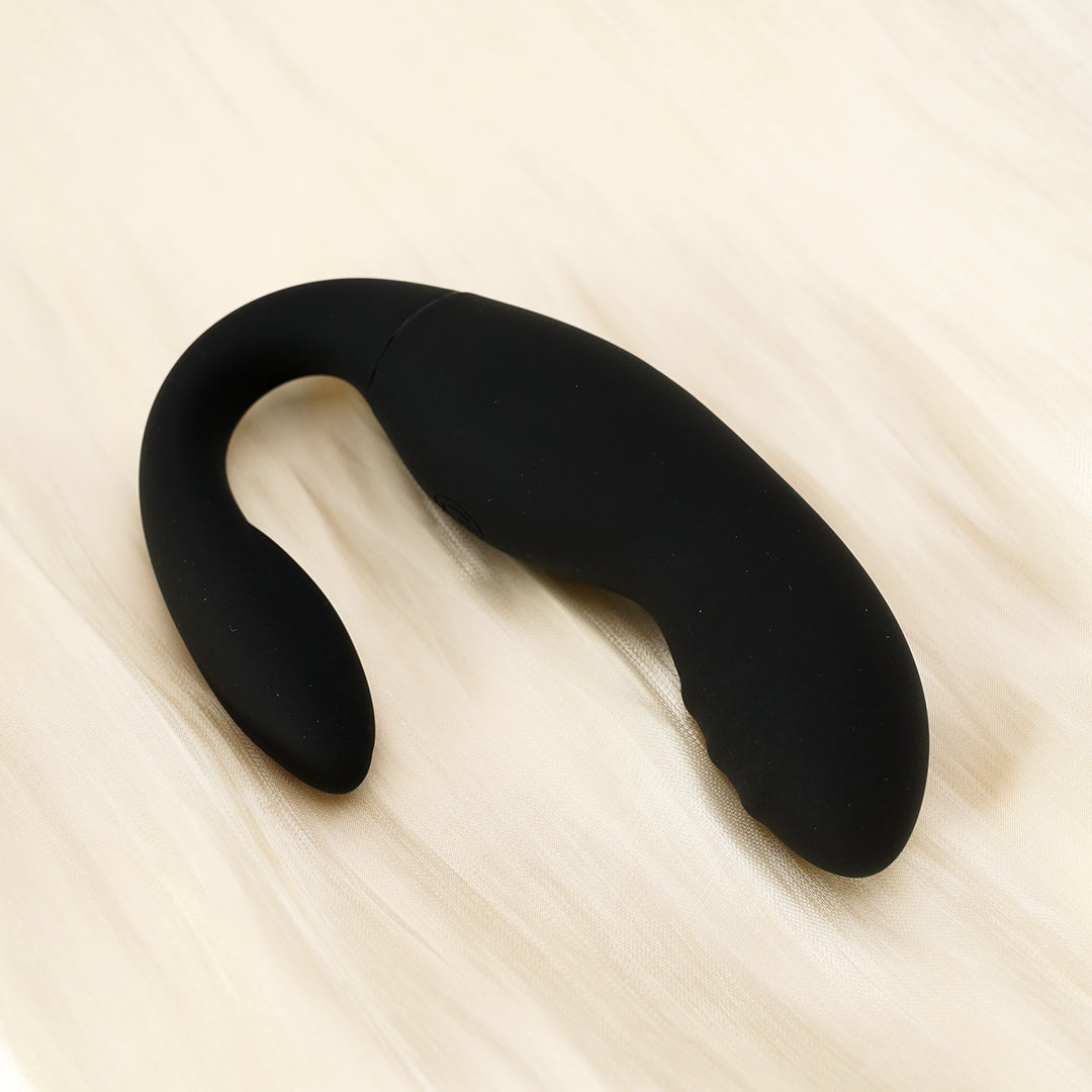 Black prostate massager on white background