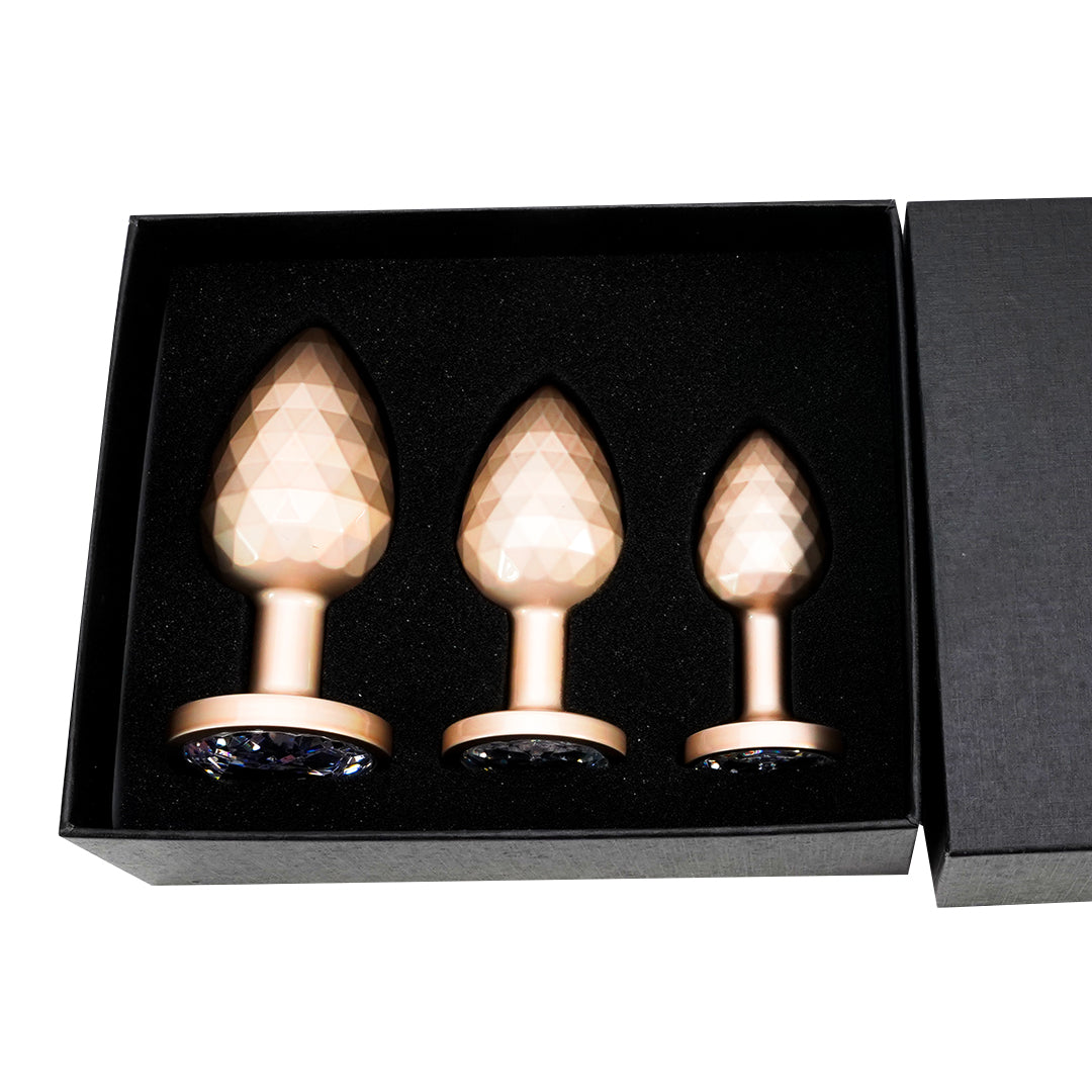 Gold metal butt plug set with crystal base, inside a black box
