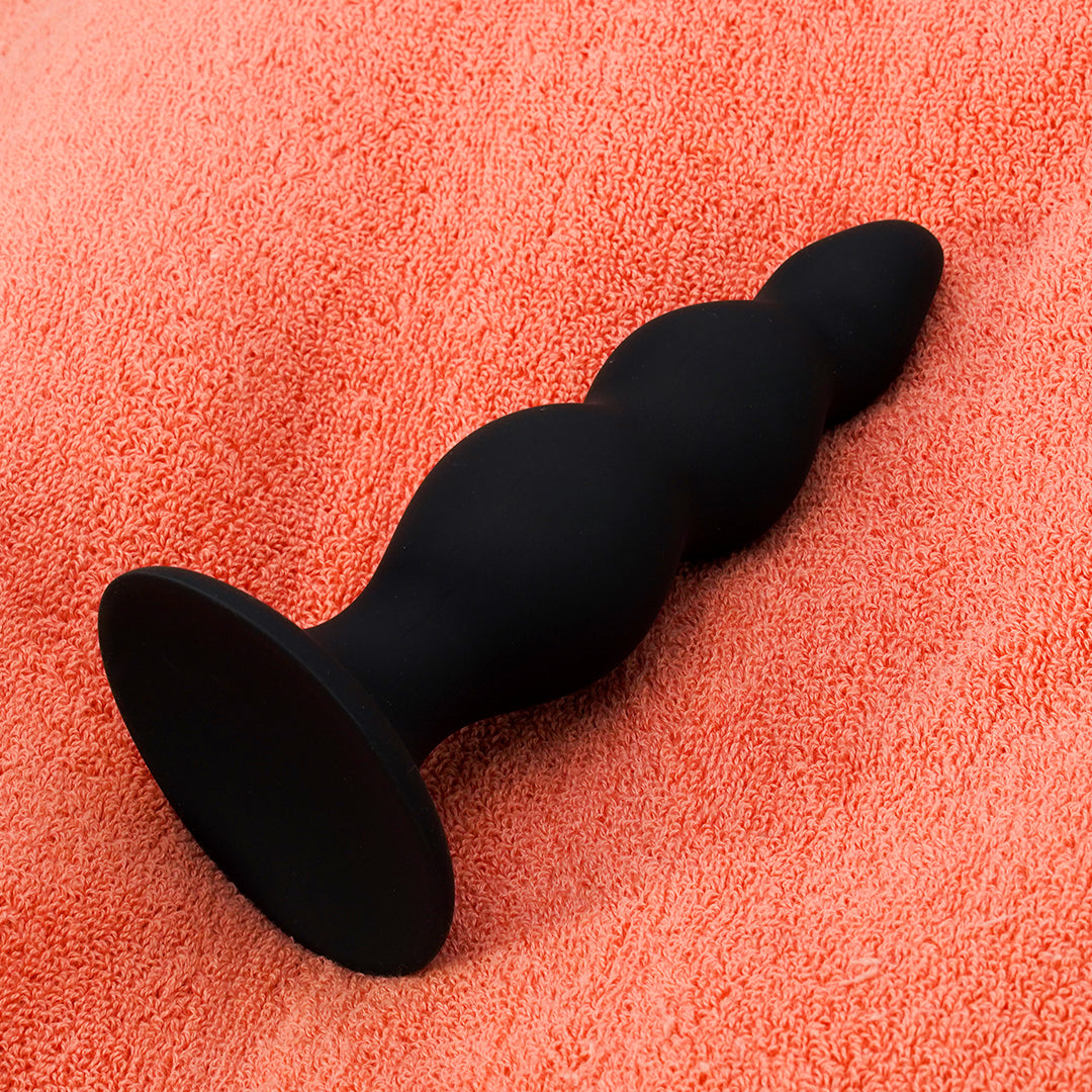 Nathan Beaded Black Anal Dildo on orange background