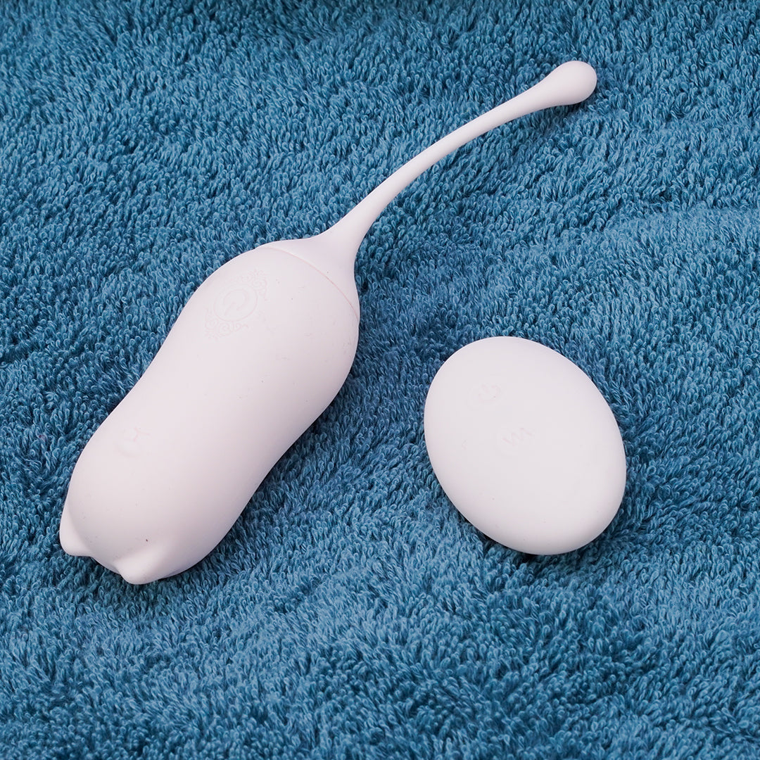 White remote control vibrator with remote on blue towel