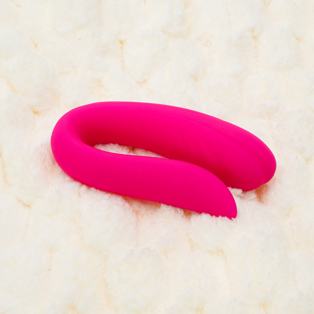Pink Couples Vibrator on a soft surface