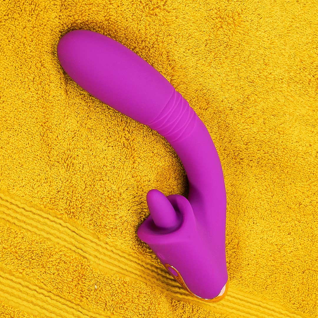 Purple rabbit vibrator on yellow towel, clit and G-spot stimulation.