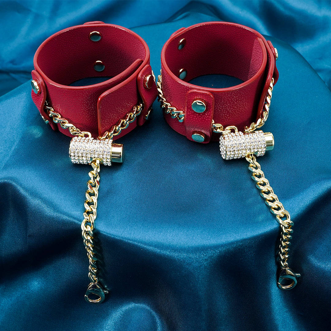 Red leather cuffs with gold chain detail