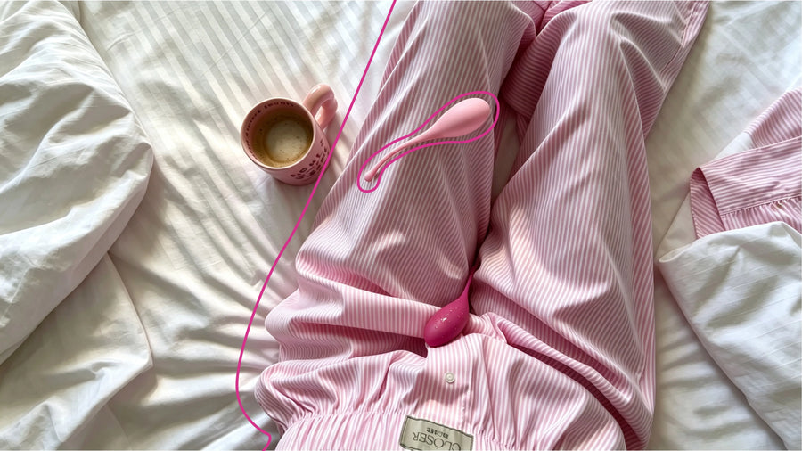 Pink pelvic exercise device on striped pajamas beside a coffee mug