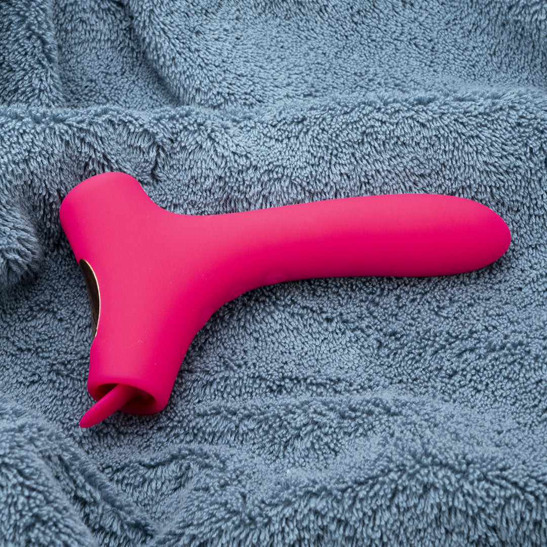 Pink Trio Pleasure vibrator on gray towel