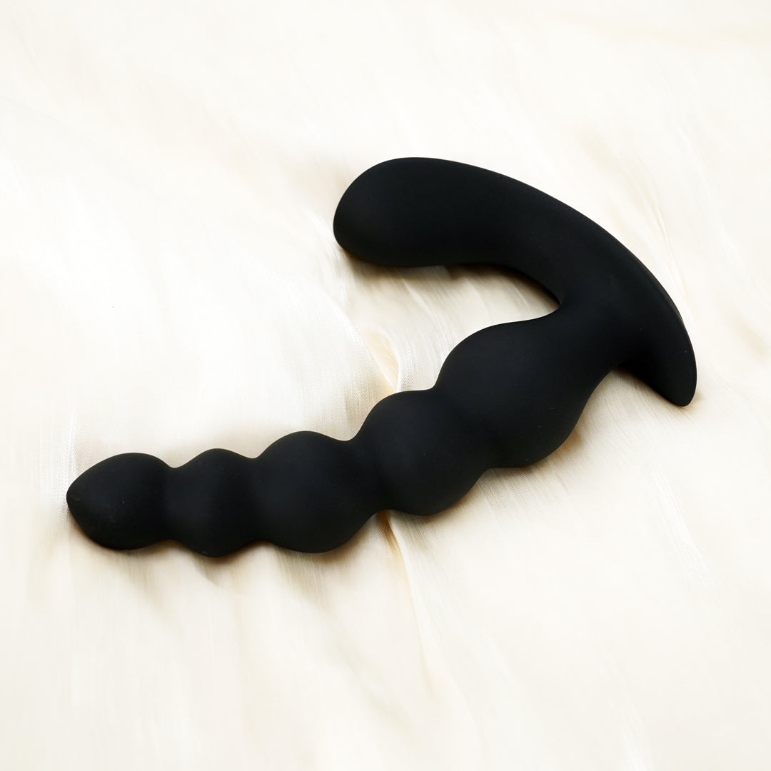 Black prostate massager with textured shaft and curved design