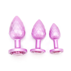 Pink metal butt plug set. 3 piece jewel design