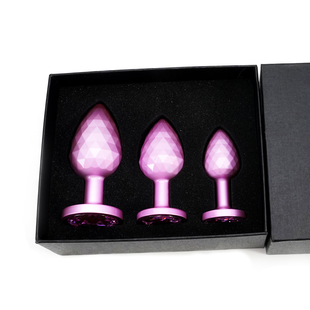 Pink faceted metal butt plug set in black box