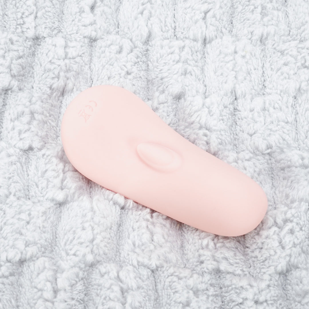 Pink Wing Rechargeable Love Egg Vibrator on white fabric background