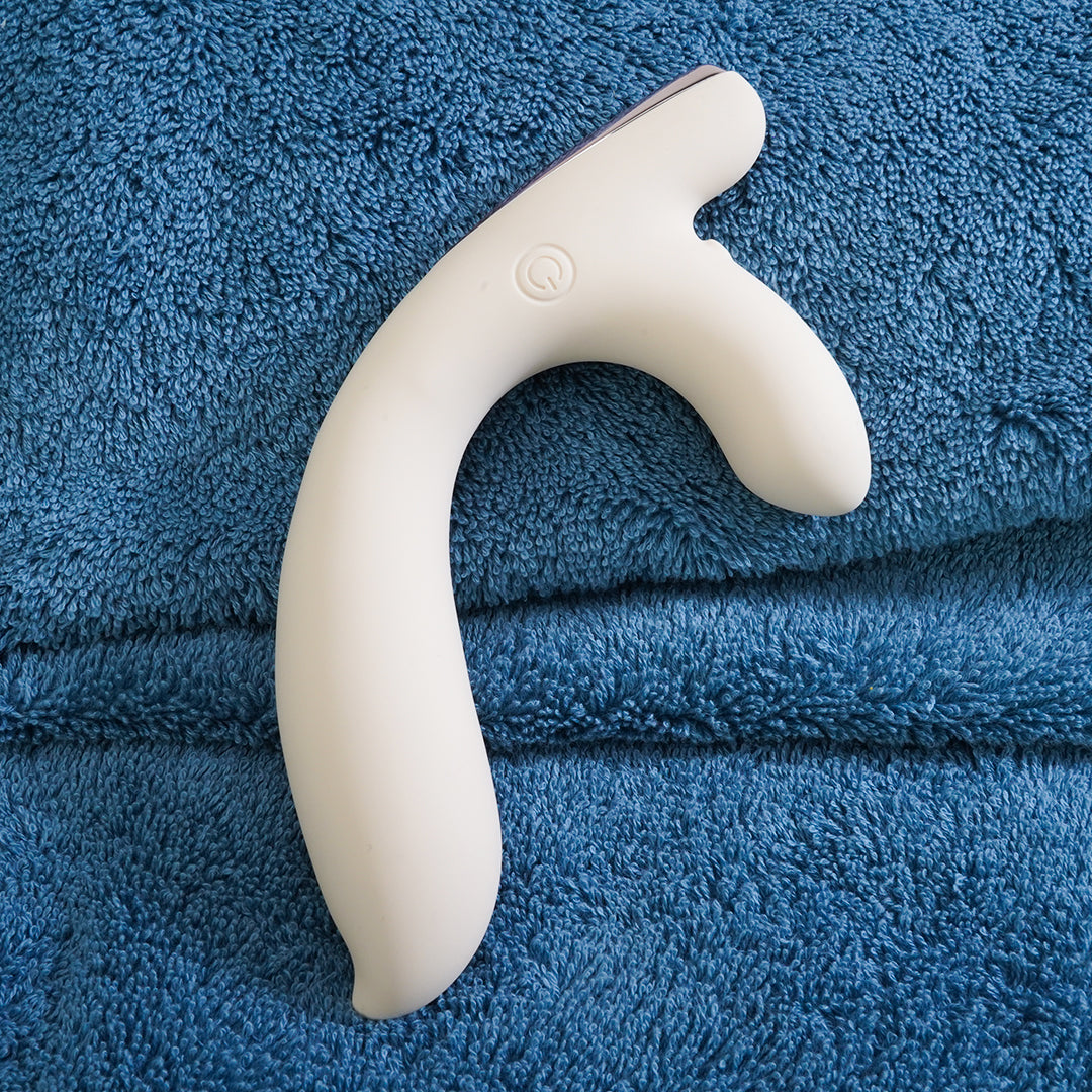 White vibrator on blue plush background - Bad Peach product