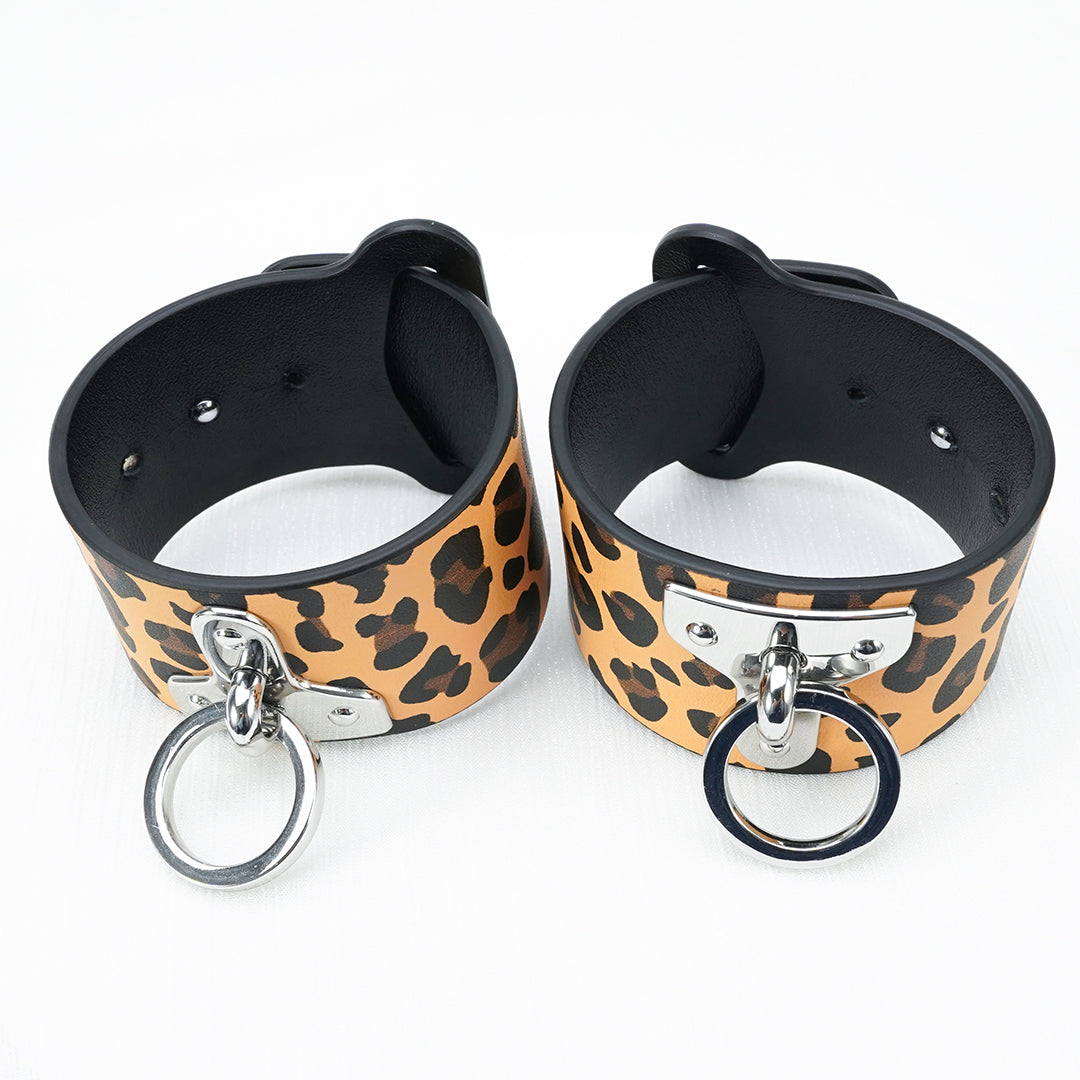 Leopard print wrist cuffs with metal rings for BDSM play