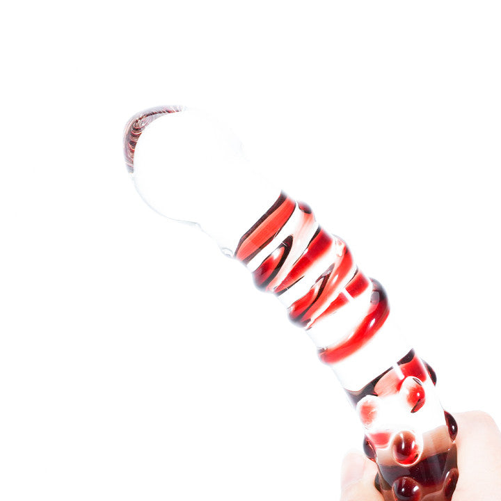 Ruby glass dildo, spiral design, held by hand